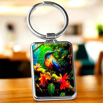 Porte-clés avec image d'un colibri sur une branche fleurie.